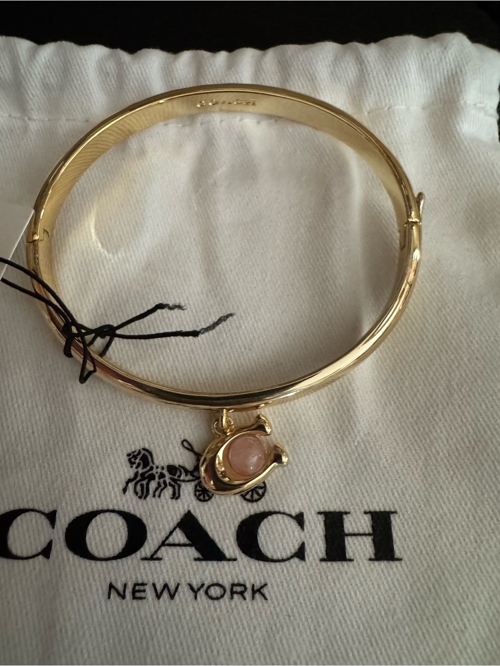 Coach Gold-Tone Bangle with Blush Pink Stone Charm